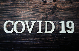 Wood letters that say COVID 19